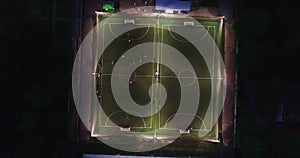 Aerial urban cityscape people training on football soccer pitch establishing shot 4K