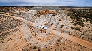 Aerial veiw of four wheel drive vehicle and large caravan on an road.