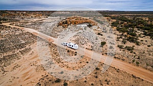 Aerial veiw of four wheel drive vehicle and large caravan on an road. photo