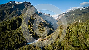 Aerial of Ventisquero Colgante, a hanging Glacier with waterfall and lake in queulat national park. photo