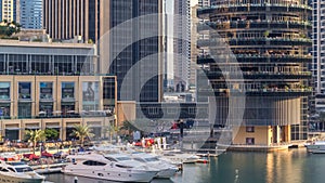 Aerial vew of Dubai Marina with shoping mall, restaurants, towers and yachts timelapse, United Arab Emirates.