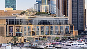 Aerial vew of Dubai Marina with shoping mall, restaurants, towers and yachts timelapse, United Arab Emirates.