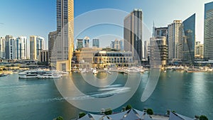 Aerial vew of Dubai Marina with shoping mall, restaurants, towers and yachts timelapse, United Arab Emirates.