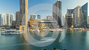 Aerial vew of Dubai Marina with shoping mall, restaurants, towers and yachts timelapse, United Arab Emirates.