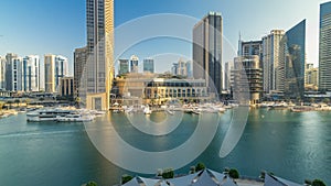 Aerial vew of Dubai Marina with shoping mall, restaurants, towers and yachts timelapse, United Arab Emirates.
