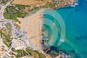 Aerial vew from fying drone view of the wild beach with sunbathers resting people