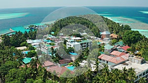 Aerial video from a drone over a typical bungalows and hotel for tourists in the Maldives. View from the drone on the roofs of the