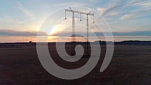 Aerial video of the electric pole with wires against sky at sunset