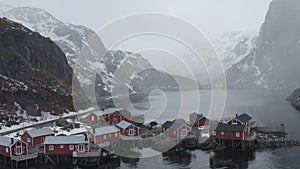 Aerial video of famous fishing village called nusfjord located in lofoten islands north of norway. Moody weather, snowing ang clou