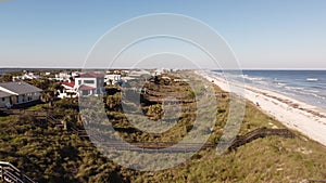 Aerial video Florida beach vacation homes with walkway over dunes to ocean