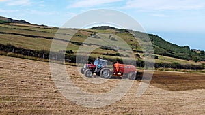 Aerial Video of Massey Ferguson 390T Tractor Abbey Tanker spreading manure in a field on a farm in UK
