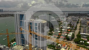 Aerial video Miami Beach bay-front condos and construction cranes