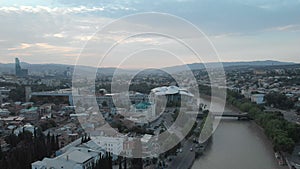 Aerial video. Old Tbilisi center from above. Drone top view on historical part of city. Kura or Mtkvari river with glass