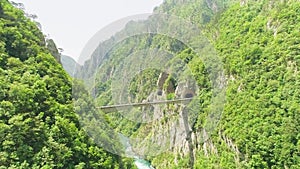 Aerial video. Shooting a beautiful deep canyon and bridge on a sunny summer day