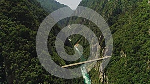 Aerial video. Shooting a beautiful gleby gorge and bridge on a sunny summer day