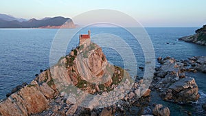 Aerial video. The Sveta Nedelja - Christian church on a tiny island in the sea close to the city of Petrovac Lots of