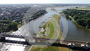 Aerial video of train driving over the ijssel river in Deventer, the Netherlands