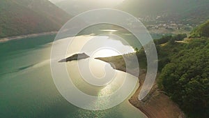 Aerial video. View of the beautiful blue mountain lake. Piva lake