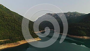 Aerial video. View of the beautiful blue mountain lake. Piva lake