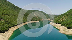 Aerial video. View of the beautiful blue mountain lake. Piva lake