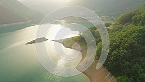 Aerial video. View of the beautiful blue mountain lake. Piva lake