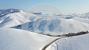 Aerial video of winter road and trees under snow in Altai. Siberia, Russia