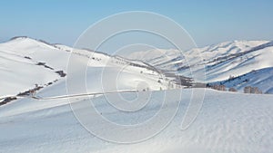 Aerial video of winter road and trees under snow in Altai. Siberia, Russia