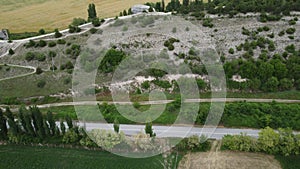 Aerial viev of lush green farm field with rocky cliffs in the distance. beauty of rural areas and the agricultural