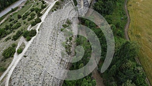 Aerial viev of lush green farm field with rocky cliffs in the distance. beauty of rural areas and the agricultural