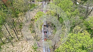Aerial View of an 1860`s Steam Passenger Train Traveling Thru a Wooded Area