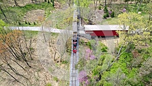 Aerial View of an 1860`s Steam Passenger Train Traveling Thru a Wooded Area