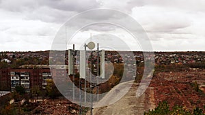 Aerial view of 4G and 5G telecommunications tower cellular network antenna on the roof of a building