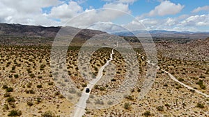 Aerial view of 4x4 car driving off road in the desert. Joshua Tree