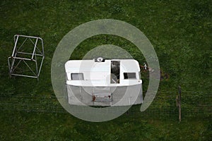 Aerial View of Abandoned Caravan Overturned in Lush Greenery