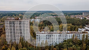 Aerial view of the abandoned ruined multi-storey buildings at the street block in Pripyat ghost town