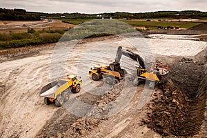 Aerial view above a digger and dumper truck on a brownfield site in the construction industry