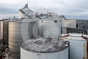 Aerial view above large scale storage tanks and silos at a chemical plant