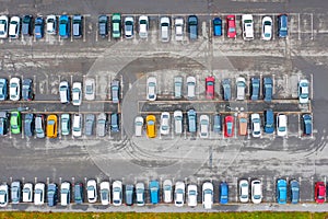 Aerial view from above of the parking lot with cars in the business district of the city, wet asphalt