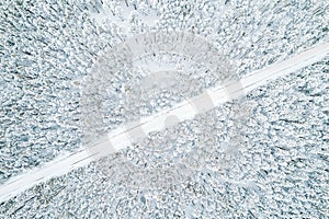 aerial view from above of the road in winter and the forest