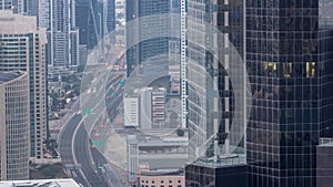 Aerial view from above to a busy road intersection in Dubai night to day timelapse.