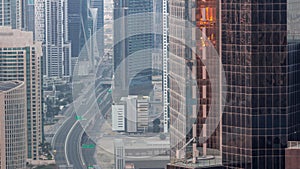 Aerial view from above to a busy road intersection in Dubai night to day timelapse.