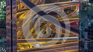 Aerial view from above to a busy road junction in Dubai night timelapse.