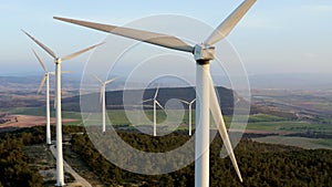 Aerial view of aeolian generators field in the top of a hill.