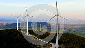 Aerial view of aeolian generators field in the top of a hill.