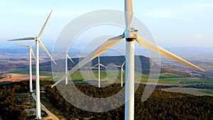 Aerial view of aeolian generators field in the top of a hill.