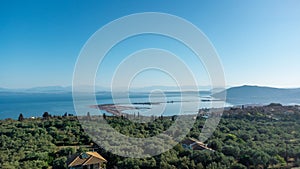 Aerial view of Agios Ioannis beach in Lefkada island in Greece. In front are the olive trees and in distance is mainland