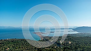 Aerial view of Agios Ioannis beach in Lefkada island in Greece. In front are the olive trees and in distance is mainland