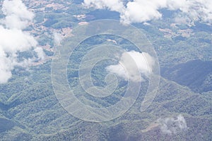 Aerial view of agricultural fields, river, mountains, and land have seen through the airplane window