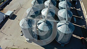 Aerial view of agricultural land and grain silo. Steel Grain Silos Elevators Storage 4K Aerial Video. Agriculture Industry