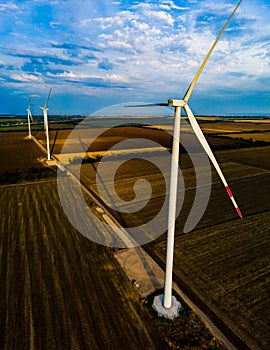 Aerial view of air turbines in a cultivated wheat field in a stopped position